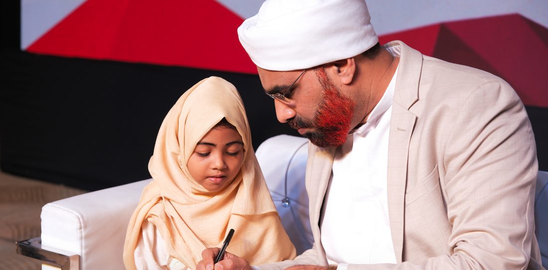 Scholar signing certificate with student