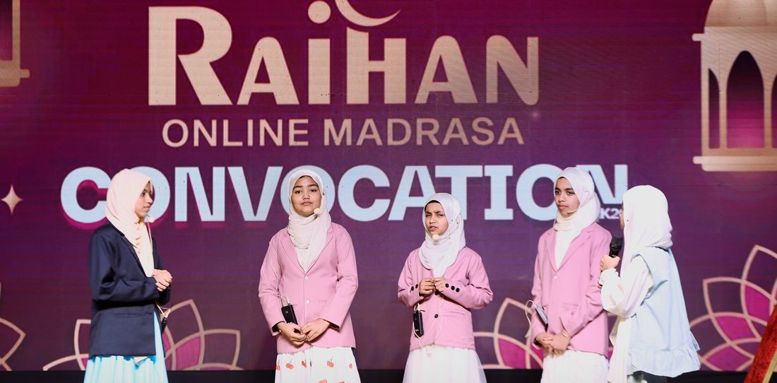 Students in pink uniforms on stage