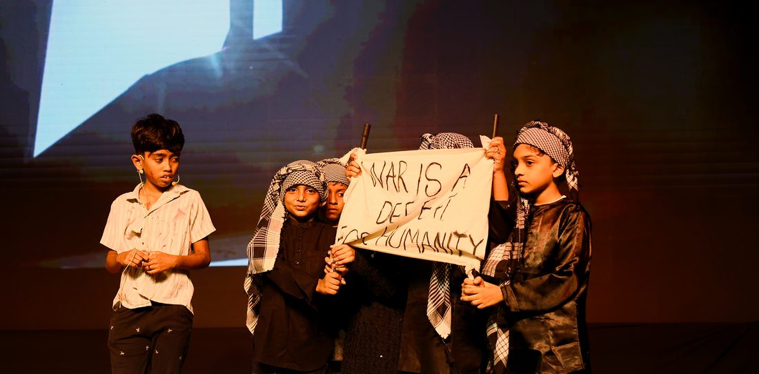 Students with peace message banner