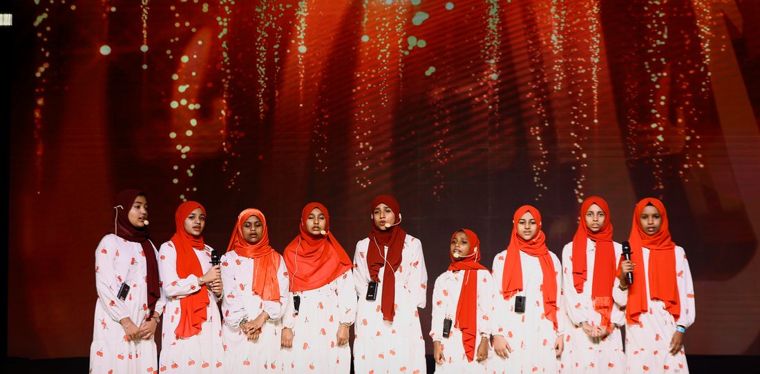 Nasheed group in red and white