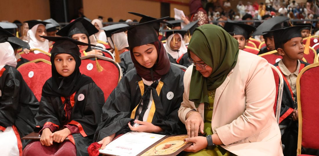Teacher helping student at convocation